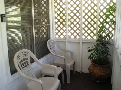 Vacation rental house has a private screened in porch